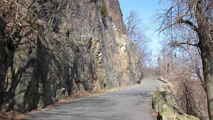 Photo of roadway and rock wall in Pallisades State Park, NJ.