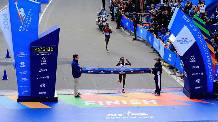 Photo of New York City Marathon finish line with winner about to break through the tape.